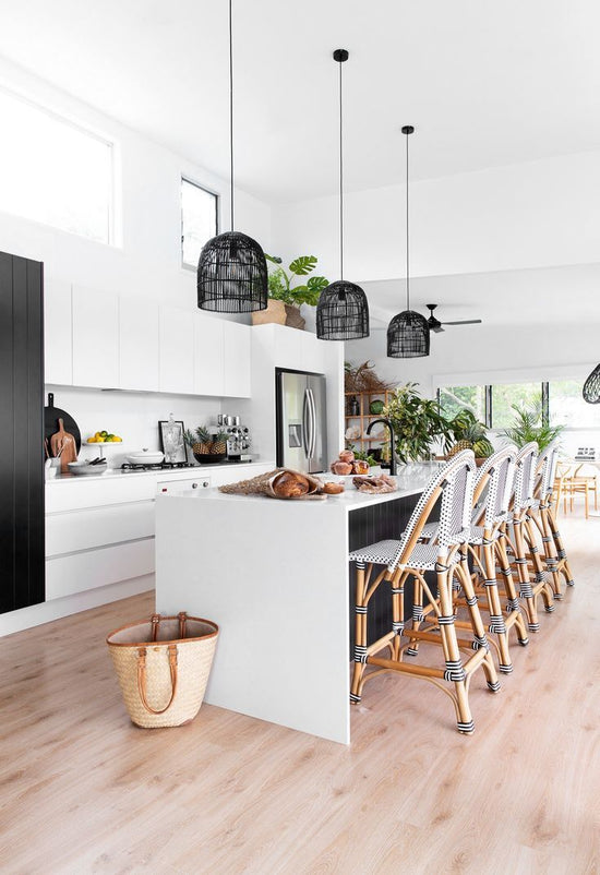 3 black small pendant lights above a kitchen counter
